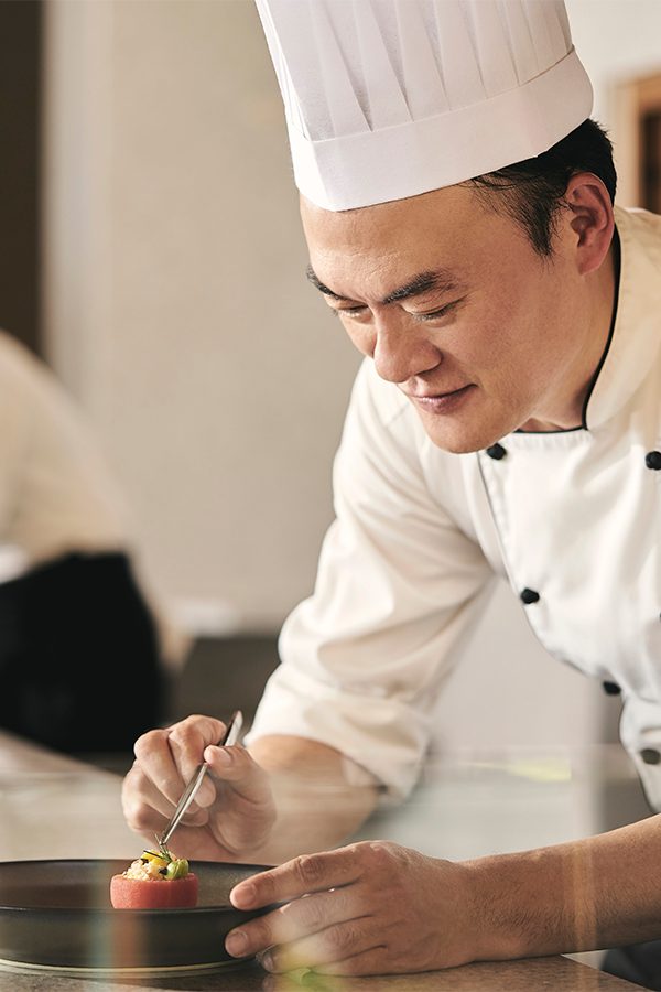 Chef Sinchai plating a dish 